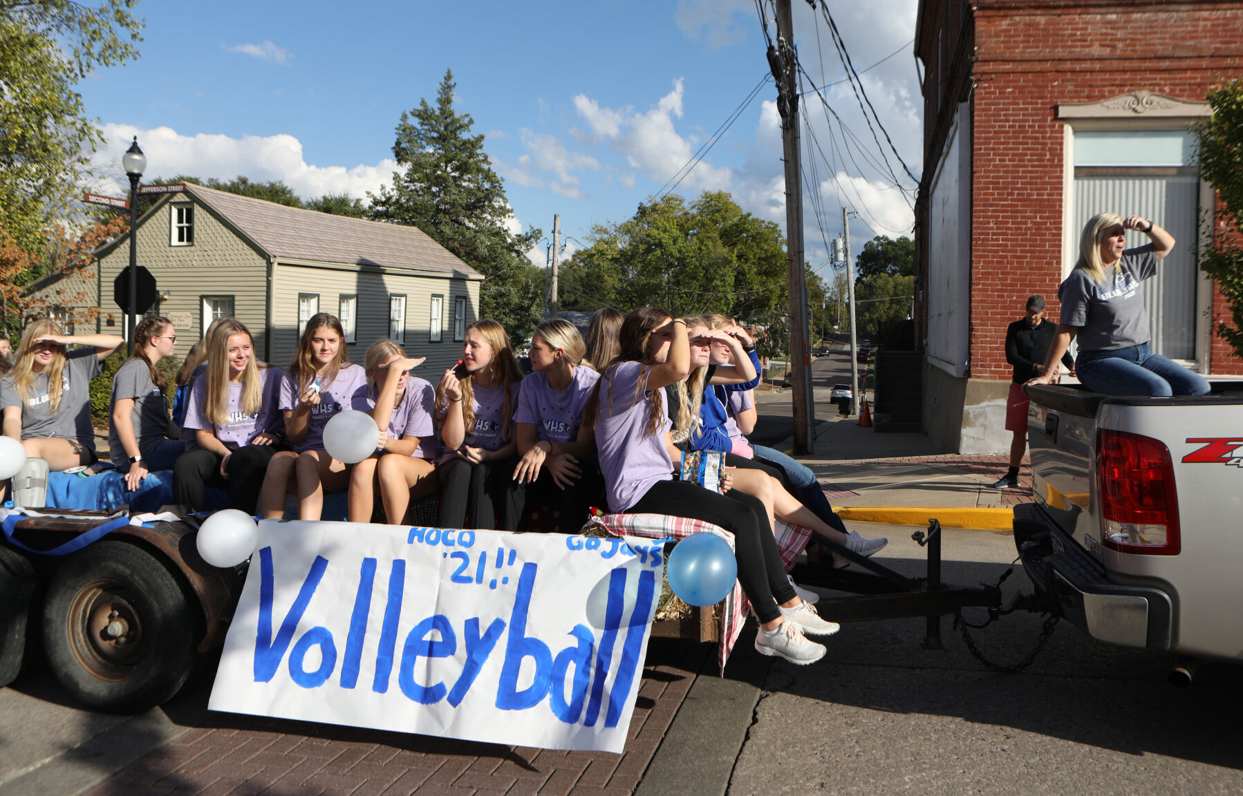 Volleyball members ride in parade